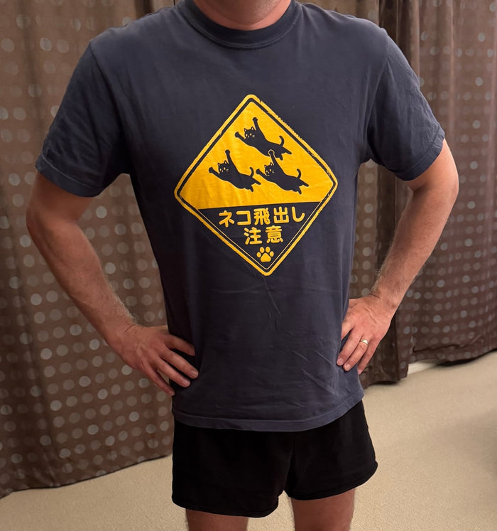 Deb F.'s husband in his Beware Flying Cats tee