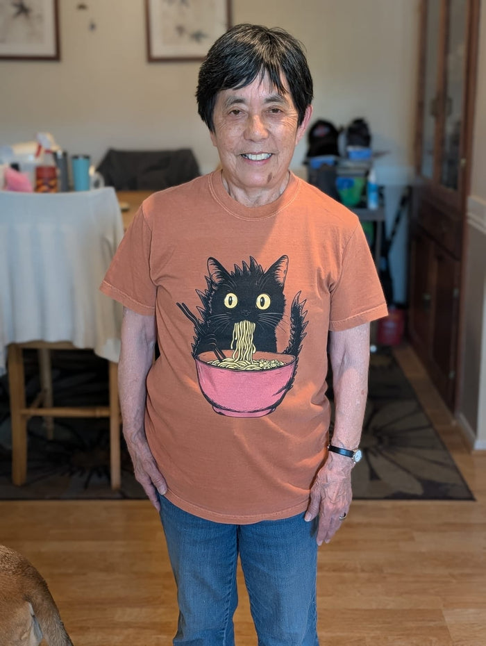 Scott D.'s mom smiling in her Kyattojira's Fav Ramen tee