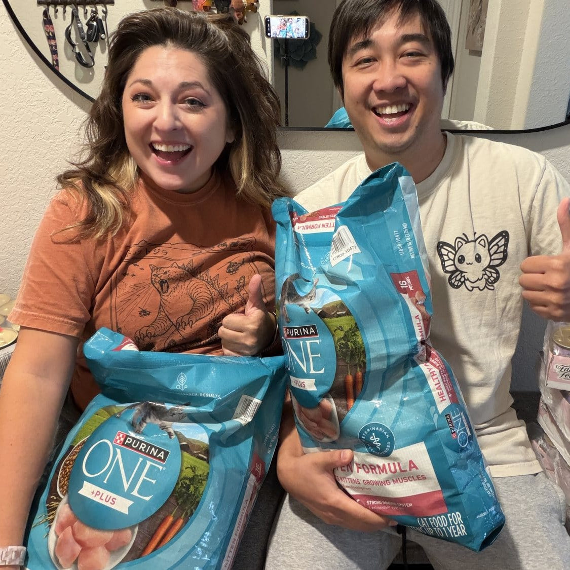 Jo and Vanessa with the cat food donated to Helotes Humane Society